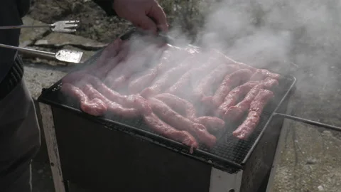 A man grills cevapi, a traditional dish made of minced meat Stock Footage 181991633