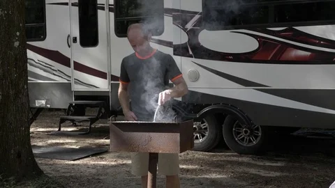 Man Grills in Front of 5th Wheel Camper Stock Footage