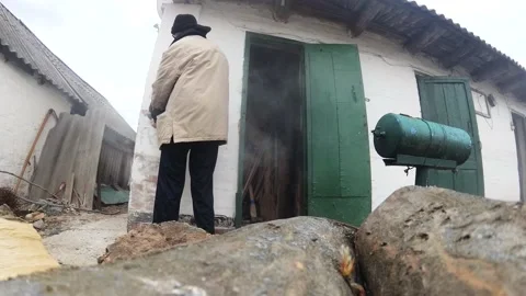 A man with a grinder with a grinding nozzle removes whitewash from an old wall Stock Footage 131709449
