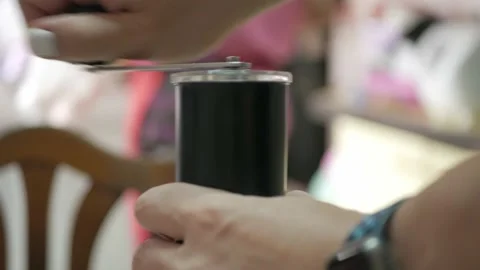 Man is grinding coffee bean with a hand grinder coffee. Stock Footage 234121392