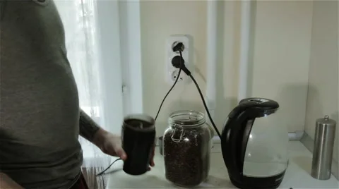 A man grinding coffee beans Stock Footage 62533790
