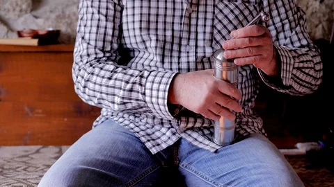 A man grinding coffee in a hand grinder. he opened it and looked inside Stock Footage 124411451