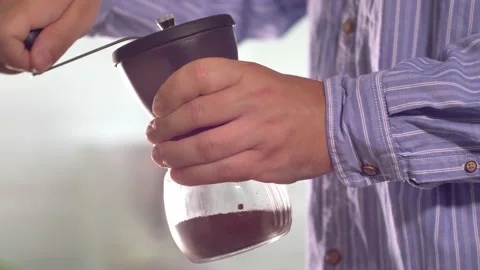 Man grinding coffee in the kitchen. Stock Footage 138468035