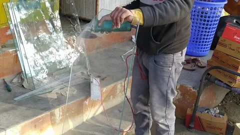 A man is grinding the glass with a machine. Stock Footage 146227022