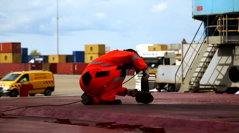 Man grinding hatch covers at port of Montoir France May 2016 Video stock 67208604