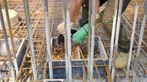 A man is grinding metal on a building construction site Stock Footage 270223953