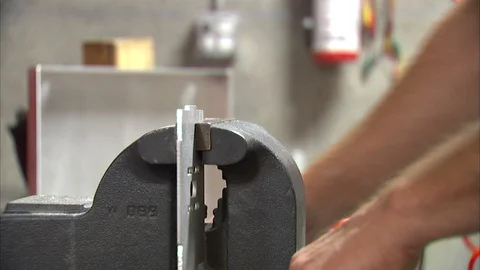 Man grinding a metal tablet Stock Footage 99048168