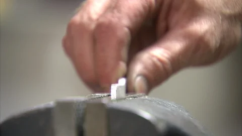 Man grinding a metal tablet Stock Footage 99048253