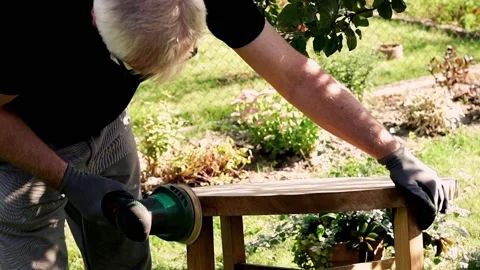 Man grinding old table in the garden, 120fps Stock Footage 126771724