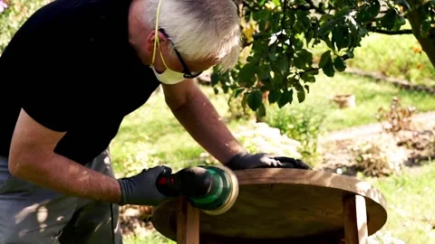 Man grinding old table in the garden, 120fps Stock Footage 126772456