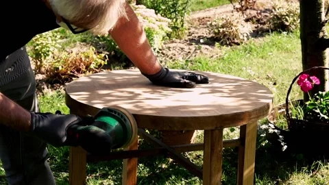 Man grinding old table in the garden, 120fps Stock Footage 126773802