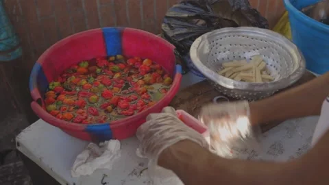 Man Grinding Pepper Sauce Manually Outdoor Stock Footage 181964579