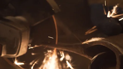 A man grinds an axe with a grinder, close-up Stock Footage 128988561