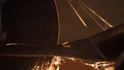 A man grinds an axe with a grinder, close-up Stock Footage 128988573