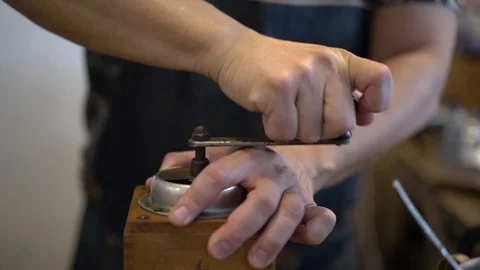 Man grinds coffee beans with vintage wooden grinder, old school brewing process Stock Footage 108252575