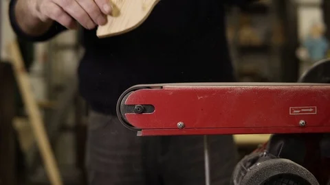 Man grinds the fish shape pattern with grinding machine with sawdust flying into 스톡 동영상 121451375
