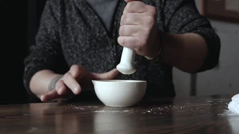 Man grinds lime in a mortar. grinding the ingredient with a mortar and bowl Stock Footage 166557826