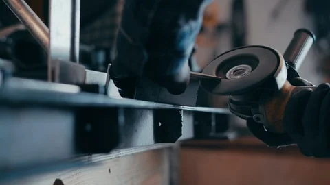 Man grinds metal with tool Видео 104076958