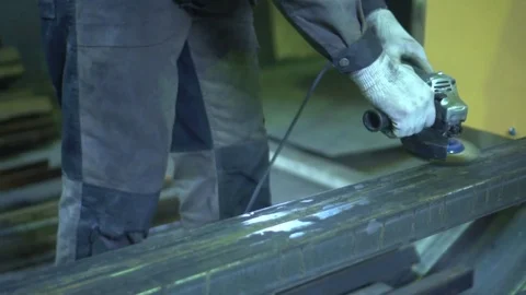 The man grinds metal. Worker's hands close up. Hands in special working gloves Stock Footage 81551417