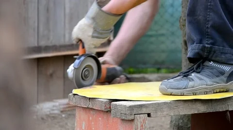Man grinds a piece of iron Stock Footage 43258030