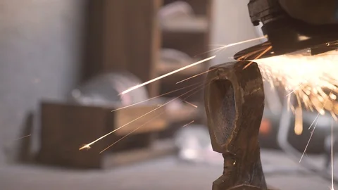 Man grinds the workpiece the axe Stock Footage 129040215