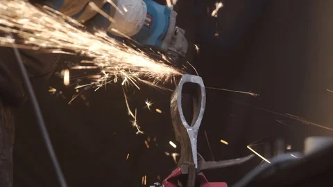 Man grinds the workpiece the axe Stock Footage 129040659