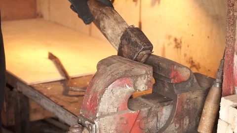 Man gripping an ax in a vice Video stock 101478134