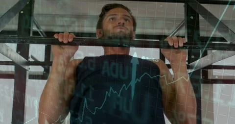 Man gripping bar and doing pullups while finance charts overlaying across Stock Footage 331757294