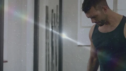 Man gripping chrome dumbbell, starting steady biceps curls for fitness, flares Stock-Footage 323455178