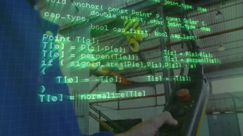 Man gripping factory robot controller showing red stop button and joystick, with Stock Footage 308100718