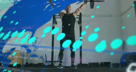 Man gripping Olympic barbell lifting overhead in fitness while overlay updating Stock Footage 317792736