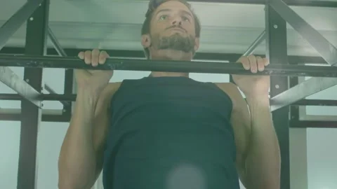Man gripping pull-up bar and starting pulling for fitness, camera capturing top Stock Footage 323455414