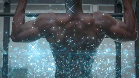 Man gripping pull-up bar doing reps while blue-sparkle overlay showing back for Stock Footage 323431702