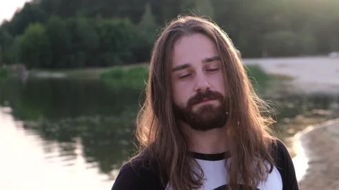Man growling at camera angrily river shore background Stock Footage 120467955