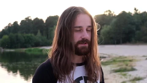 Man growling at camera angrily river shore background Stock Footage 120468111
