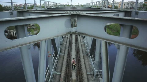 Man with guitar goes on bridge Stock Footage 50295920