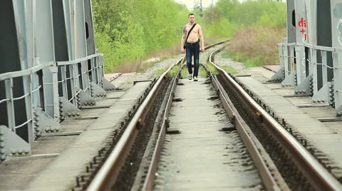 Man with guitar goes on bridge Stock Footage 50296222
