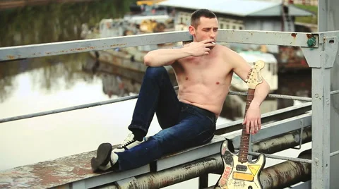 The man with the guitar smokes Stock Footage 50296583