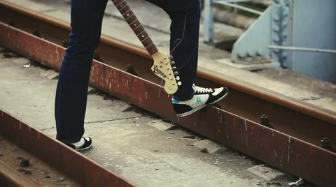 The man with the guitar standing on the bridge Stock Footage 50296265