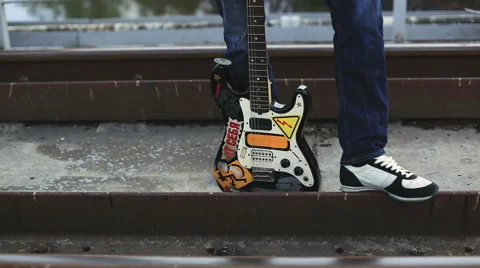 The man with the guitar standing on the bridge Stock Footage 50296389