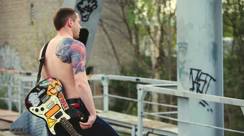 The man with the guitar standing on the bridge Stock Footage 50296482
