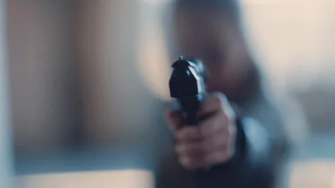 Man with gun in hand pointing, shooting. Dangerous killer, dark. Aim, armed guy Stock Footage