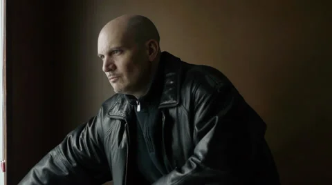 Man with Gun Looking Out Window Waiting Video stock 34669579