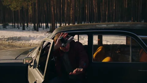 A man with a gun surrendering and exiting the vehicle Stock Footage 283107905