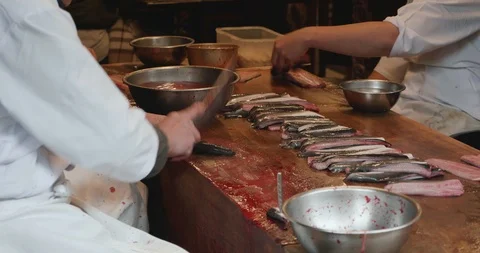 Man guts and fillets live eels Stock-Footage 107809371