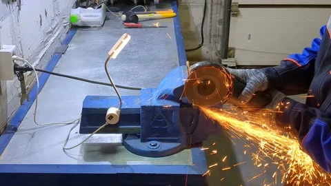 Man guy processes and cuts metal in shape Stock Footage 232570246