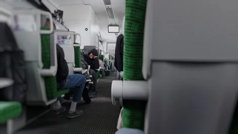 Man guy is sleeping on seat inside carriage while train is moving. Fatigue Stock Footage 315283534