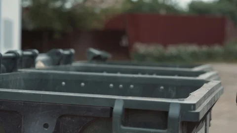 Man guy taking out the garbage in container, waste unsorted Stock Footage 111285431