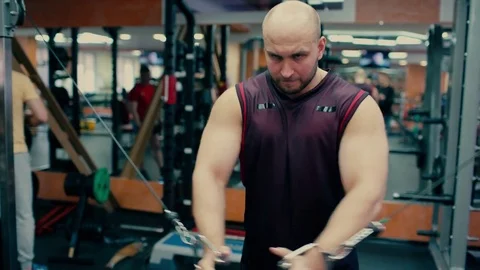 Man in gym doing pulls weight on cable machine Stock Footage 81424614