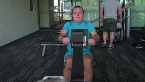 The man in the gym has been rowing Simulator Stock Footage 91588448
